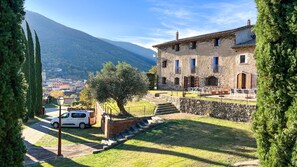 Situated in a serene natural setting, this traditional building offers a tranquil escape with a clear view of the surrounding mountains.