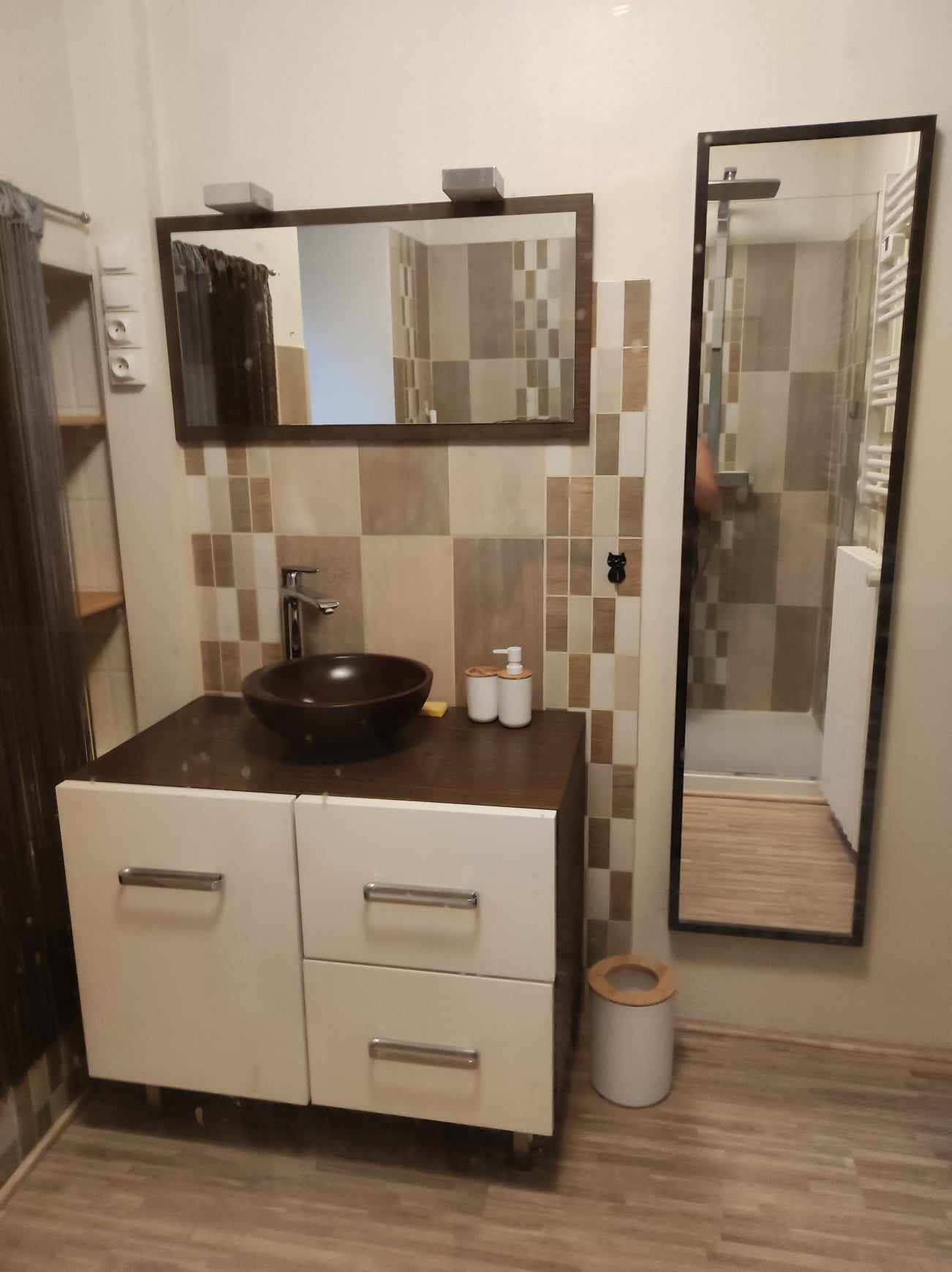 A bathroom with a sink, mirror, and a toilet.