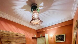 A bedroom with a bed, a desk, a chair, a door, and a ceiling fan. - Beautiful Studio in the heart of Casablanca (Casablanca)