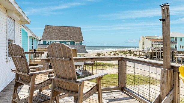 A wooden deck with Adirondack chairs overlooking a beach. - Porch Paradise - 3 Beach & Water Views, Screened Porch! (Freeport)