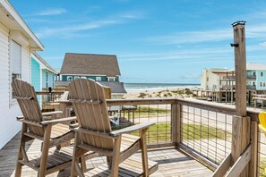 A wooden deck with Adirondack chairs overlooking a beach. - Porch Paradise - 3 Beach & Water Views, Screened Porch! (Freeport)
