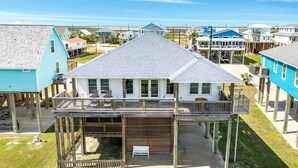 A two-story house with a balcony, a covered porch, and a small deck area. - Porch Paradise - 3 Beach & Water Views, Screened Porch! (Freeport)