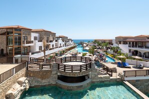A resort with a central pool, multiple balconies, and a view of the ocean. - Costa Lindia Beach Resort (Rhodes)