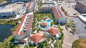 An aerial view of a hotel with multiple buildings, a swimming pool, and a parking lot. - 3BR Beach Condo: : Private Balcony & Pool Access (South Padre Island)