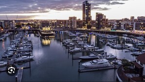 A marina with numerous boats docked, surrounded by buildings and a bridge. - Stunning 3-bed, 3-bath Apartment in Southampton (Southampton)