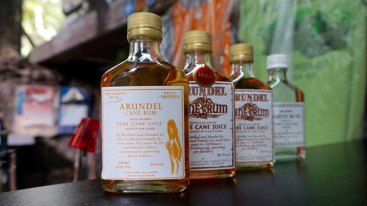 Three bottles of Arundel Cane Rum on a counter.