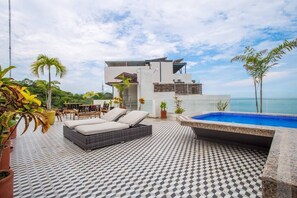 Relax in a serene outdoor oasis with a seating area, small pool, and breathtaking ocean views.