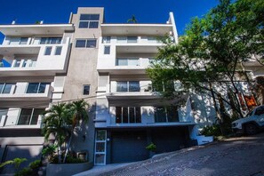Stylish residential building with a flat facade and large windows.