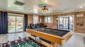 A pool table with four chairs, a foosball table, and a ceiling fan. - Waterfront Retreat w/ Dock on Lake Tawakoni! (Quinlan)