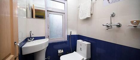 A bathroom with a sink, toilet, and shower.