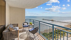 A balcony with a view of the beach and a pier. - 1606 Brighton 3 Bedroom Condo (Myrtle Beach)