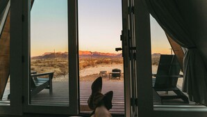 A room with a large window overlooking a desert landscape with mountains in the distance. - Stardust Big Bend Luxury A-Frame#9 with a fab view (Terlingua)