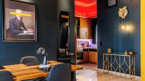 A modern interior with a dining area, kitchen, and a framed artwork on the wall. - Mimosa Urban Habitation  (Chania)