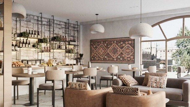 A modern bar area with a marble floor, round tables, and a variety of bottles and snacks. - Dastan Baku Hotel (Baku)