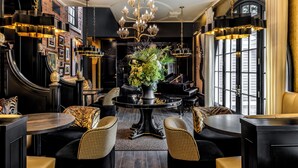 A luxurious interior with a grand piano, elegant chandeliers, and plush seating. - The Scotsman Hotel (Niagara-on-the-Lake)