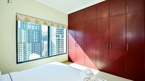 A bedroom with a large window, a bed, and a wardrobe. - Budget 1BR Apt in Marina  -Time (Dubai)
