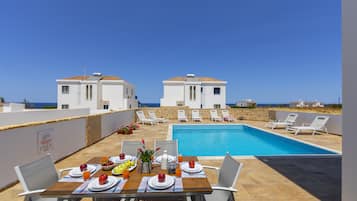 Seasonal outdoor pool, pool umbrellas, pool loungers
