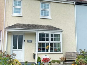 A two-story building with a sign reading 'Bithecott Cottage.'