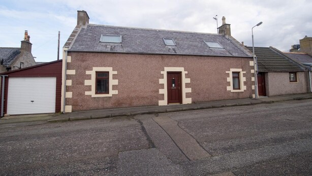 A two-story house with a pitched roof, two windows, and a door. - Come Along and Enjoy the Beautiful Moray Coast (Buckie)