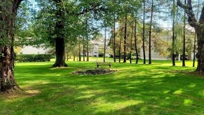 A park with mature trees and a well-maintained lawn. - Victoria House luxurious country feel. Close to Buffalo Bills stadium. (Elma Center)