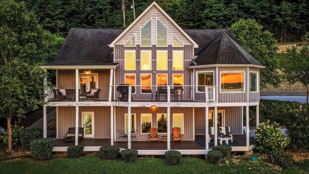 A two-story house with a balcony, a deck, and a large window. - Enjoy luxury Sunsets at the Lake! (SEVIERVILLE)