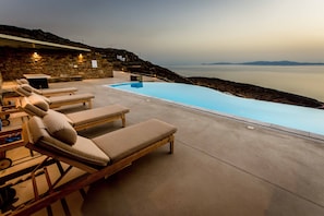 Outdoor pool, open 8:00 AM to 9:00 AM, pool umbrellas, pool loungers