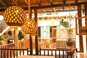 A rustic interior with wooden beams, a staircase, and hanging lanterns. - Casa Encanto Barichara (Barichara)
