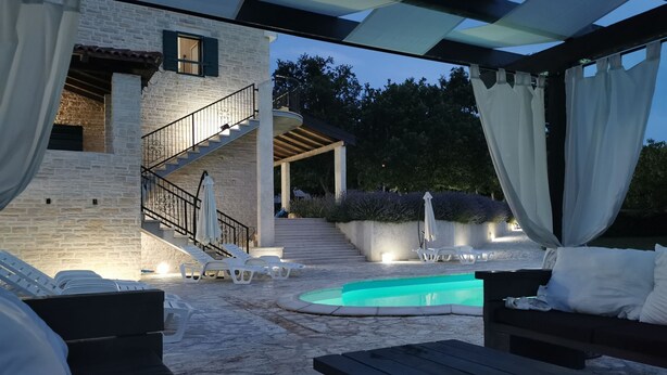 A covered outdoor area with a swimming pool, lounge chairs, and a staircase leading to an upper level. - Villa Paradiso Zadarvillas (Policnik)