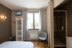 Enjoy a spacious room with a large window, wardrobe, and separate shower area.