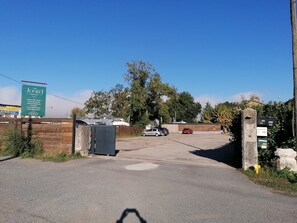 Secure entrance to Jostel, a business with ample parking.