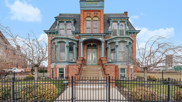 A Victorian-style building with a prominent central entrance, large windows, and a brick facade. - NEW! Brush Park Brilliance! Walk->Stadiums DT Luxe 3BR (Detroit)