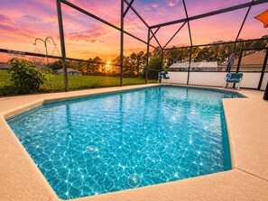 A rectangular swimming pool with a clear blue water surface, surrounded by a beige deck. - Cozy Pool Near Disney: Relax, Recharge,  sunshine pool all day (Davenport)