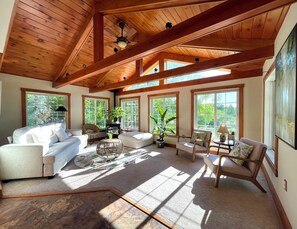 A spacious living room with a high ceiling, large windows, and wooden beams. - Berkshires sanctuary with outdoor living area & firepit. 8minutes to Tanglewood! (Richmond)