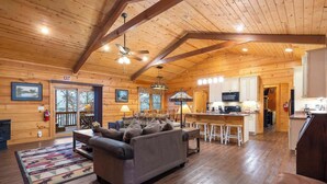 A log cabin interior with a living room, kitchen, and dining area. - Teals Treasure Secluded Lakeside Cabin for 8! (Kirbyville)