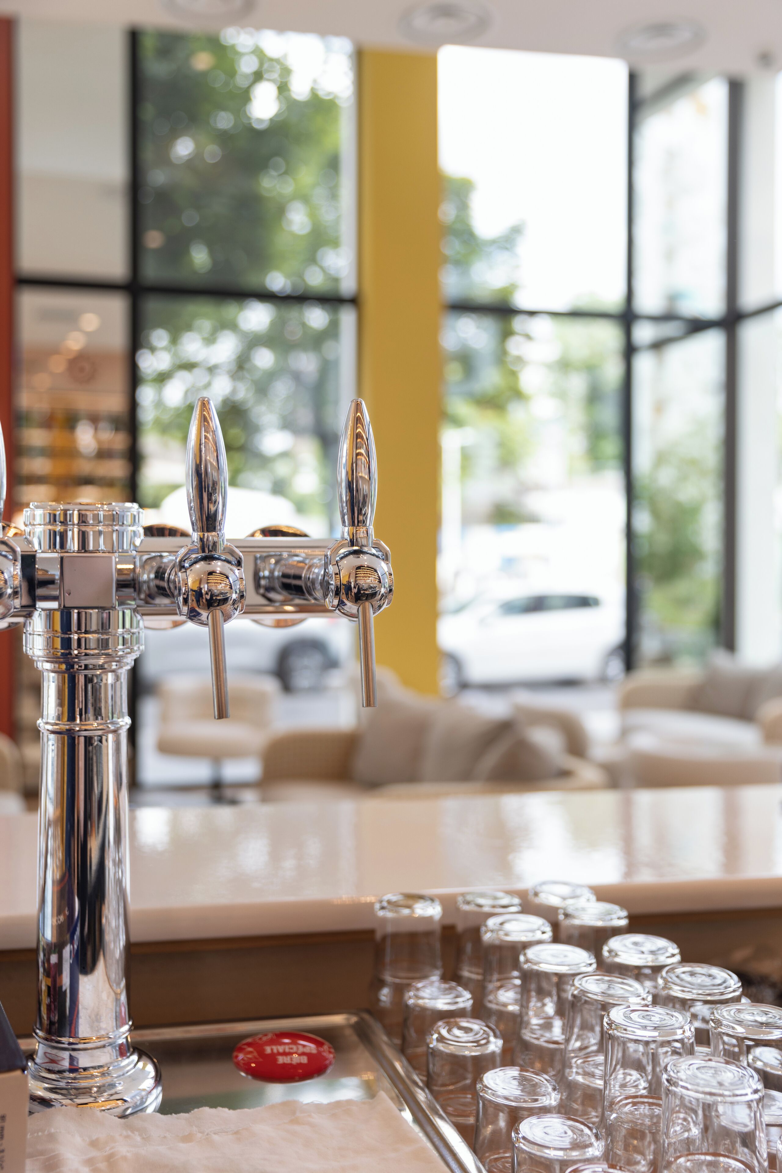 A bar area with a tap and glasses.