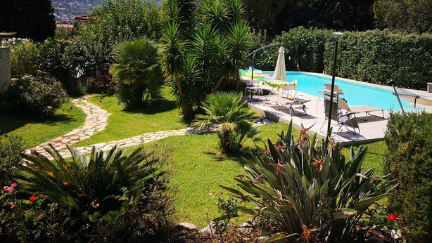 A pool area with lounge chairs and a pathway leading to the pool. - Villa Tiziana, a wonderful oasis of peace and tranquility near Palermo (Monreale)