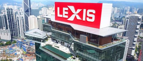 A modern building with a large red sign reading "LEXIS" on top.