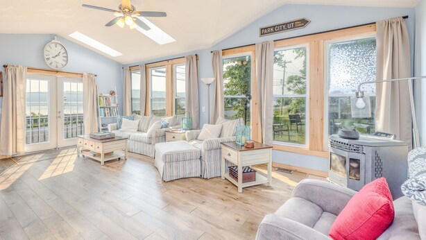 A spacious living room with a sofa set, a coffee table, and a fireplace. - 3-bedroom vacation home just 10 minutes from Adirondack Park (Ticonderoga)