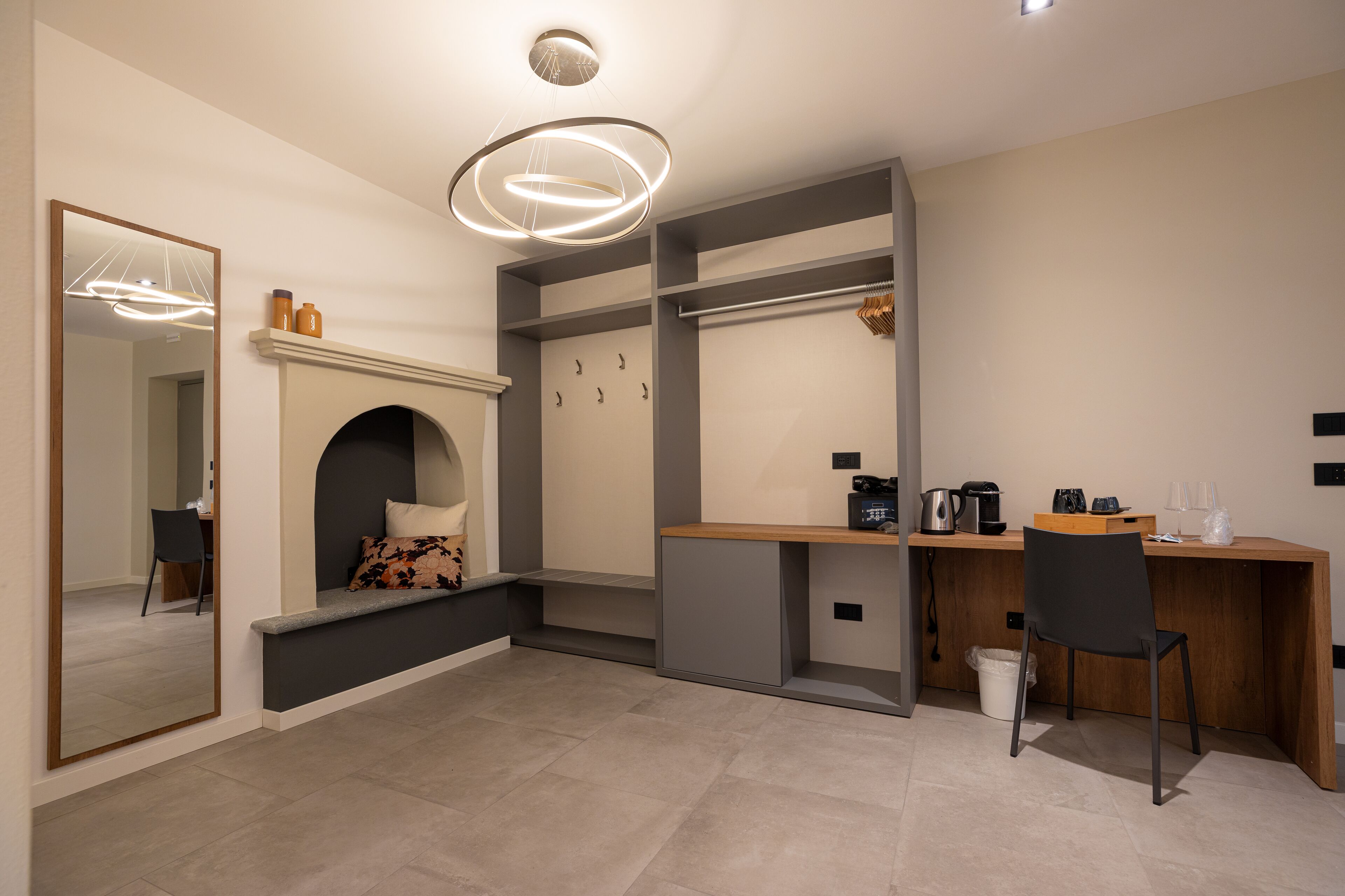 A modern kitchen with a built-in stove, a wooden countertop, and a black chair.