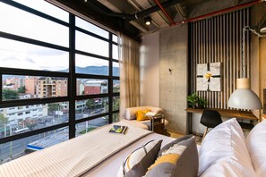 Enjoy a city view from the large window, with a comfortable bed and a desk for work or relaxation.