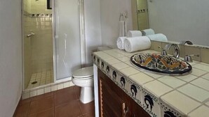 Un baño con ducha, inodoro y lavabo.
