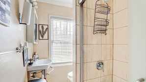 A bathroom with a sink, toilet, and shower. - Pet-Friendly Lilburn Duplex w/ Patio & Grills! (Lilburn)
