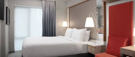 Premium bedding, desk, laptop workspace, blackout curtains