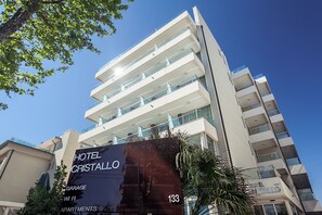 A multi-story hotel with balconies and a large sign advertising 'Hotel Cristallo' and 'Garage'. - Cristallo Rimini (Rimini)