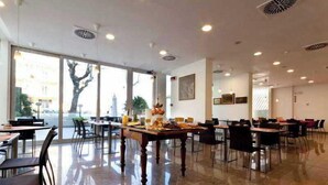 A spacious dining area with large windows, polished floors, and modern lighting fixtures. - Cristallo Rimini (Rimini)