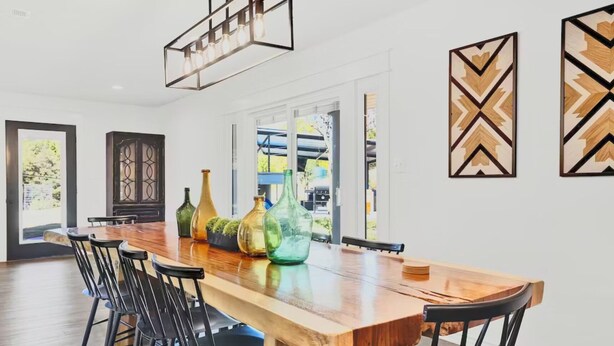 A dining area with a wooden table, black chairs, and decorative vases. - Relaxation+Pool & Hot Tub+Views (Comfort)
