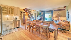 A spacious kitchen with wooden cabinets, a dining area with a large wooden table and chairs, and a cozy living room with a sofa and a fireplace. - Mountain Getaway Retreat - 4br + loft  (Beech Mountain)