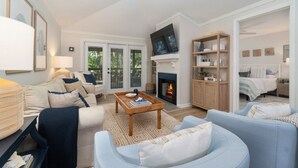 A modern living room with a fireplace, a television, and a comfortable seating area.