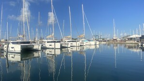 A marina with multiple sailboats docked in calm waters. - Three Bed Villa with Private Pool Set In Tropical Gardens. (Harbour View Jolly Harbour)