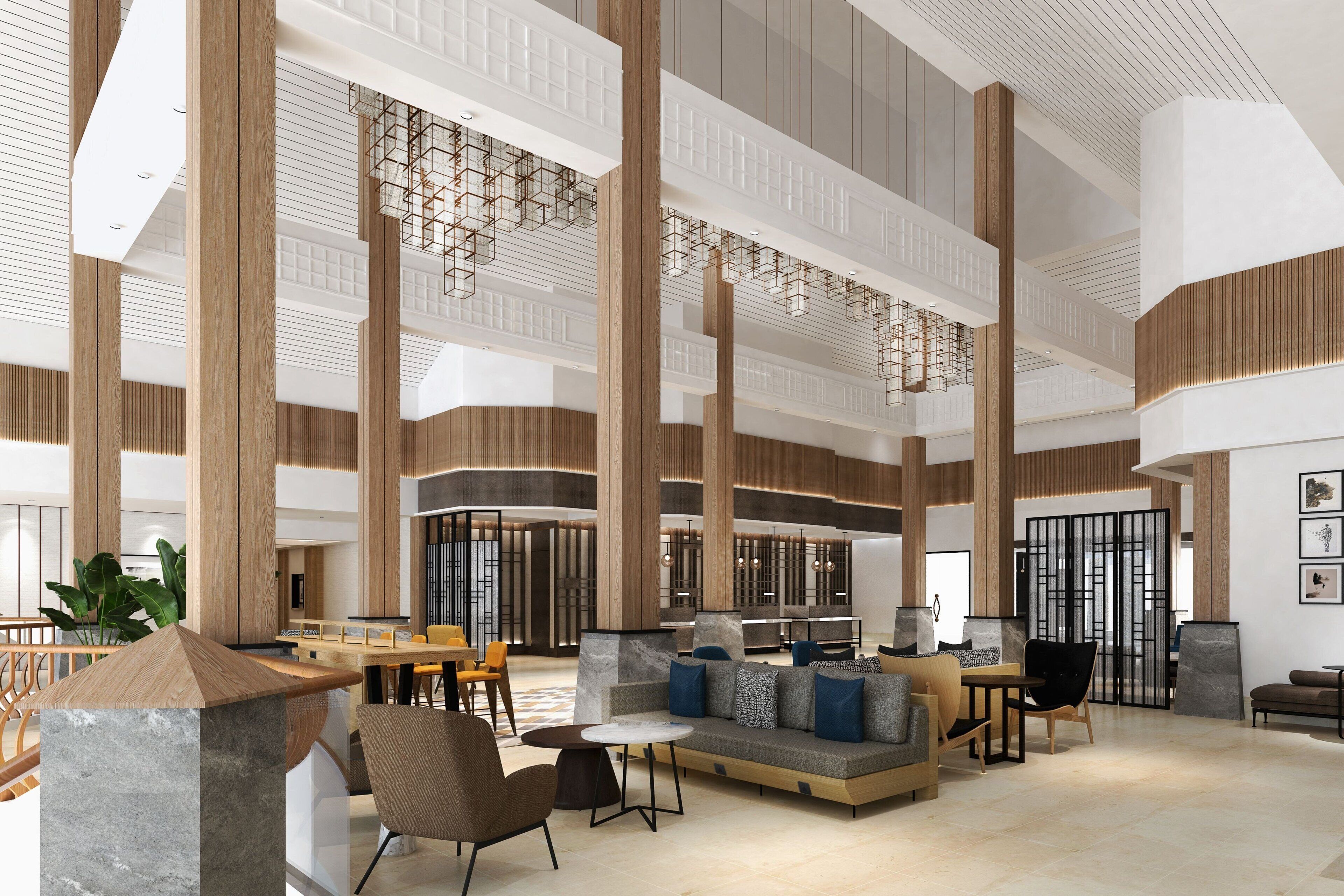 A spacious lobby with high ceilings, large wooden columns, and a modern seating area with sofas and tables.